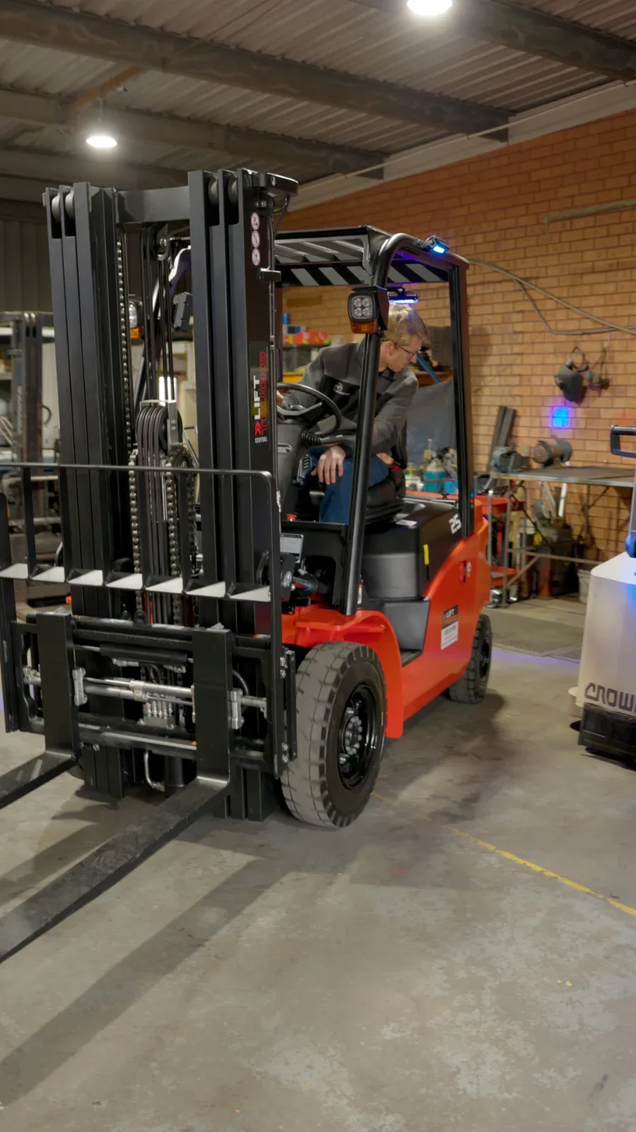 A forklift operator at work inside the warehouse