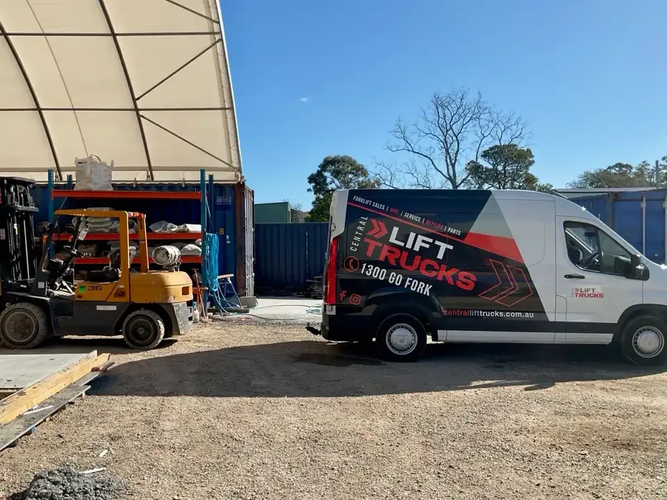A Central Lift Trucks service van in the yard beside a forklift