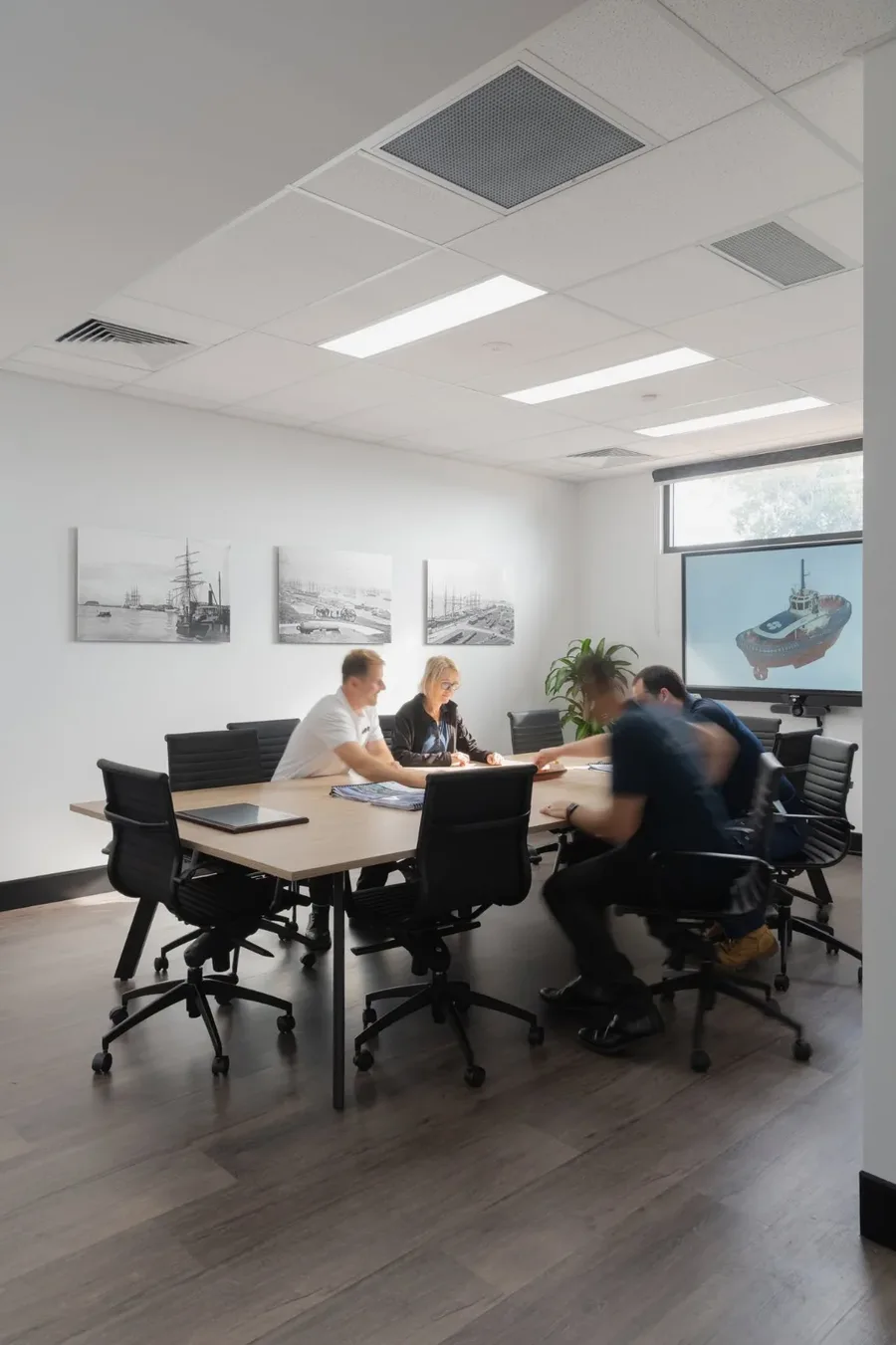The team meeting around the boardroom table