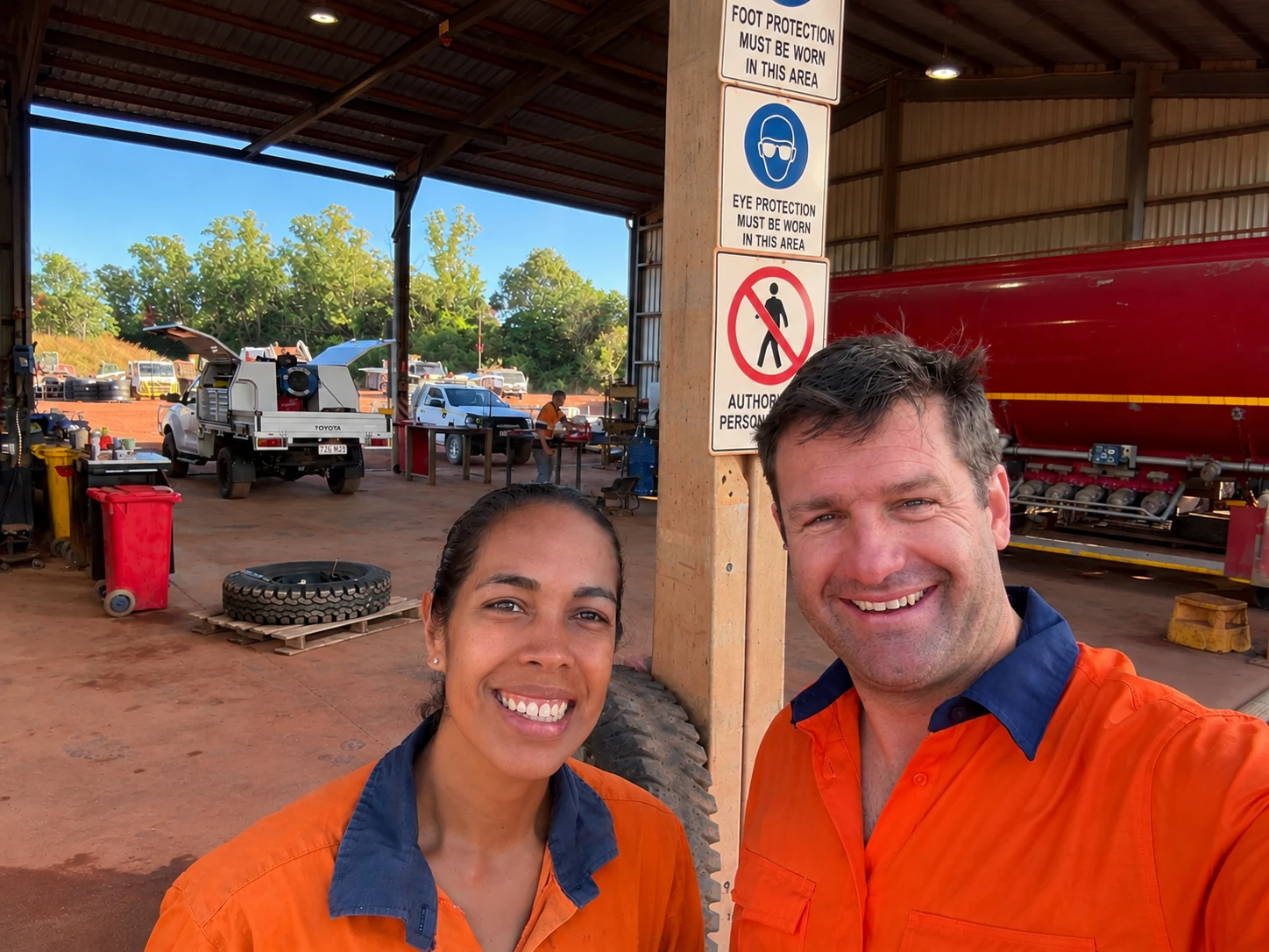 Andrew with a business owner at their yard