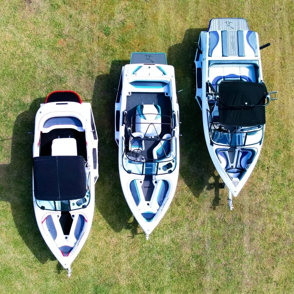 Three Lewis boats seen from above, parked on grass