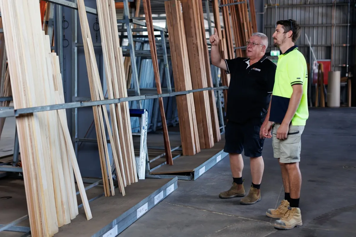 Two men looking over timber stock in the Trade Building Supplies warehouse