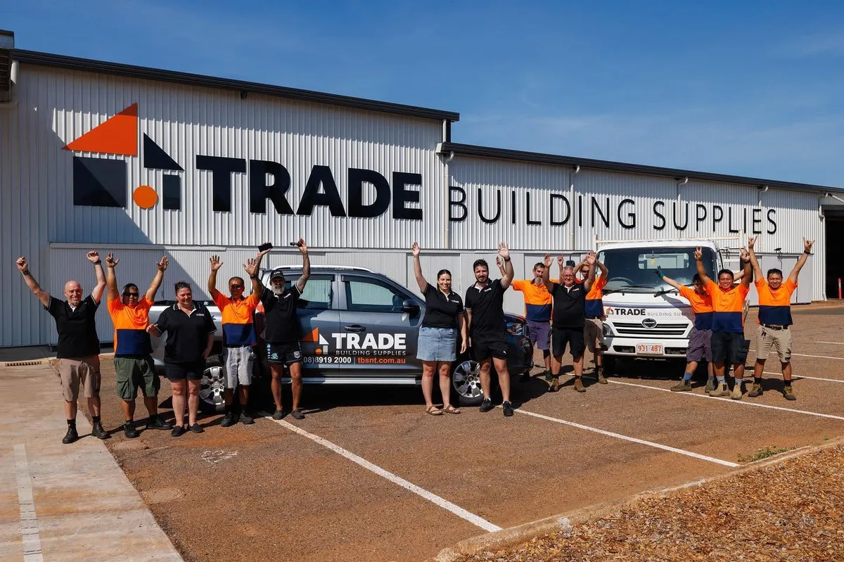 The Trade Building Supplies team celebrating outside the store