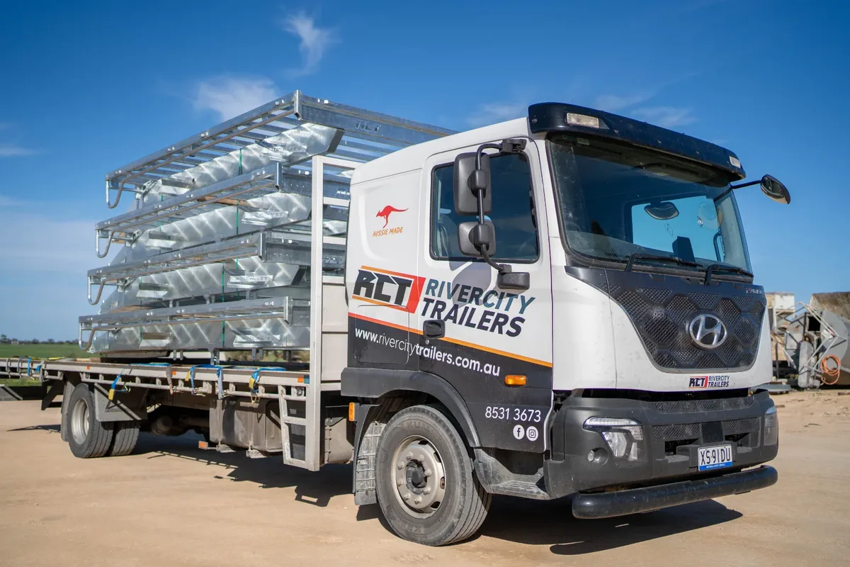 A Rivercity Trailers truck loaded with stacked galvanised livestock crates