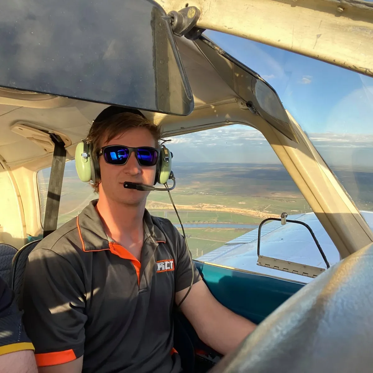A pilot in the cockpit of a small aircraft in flight